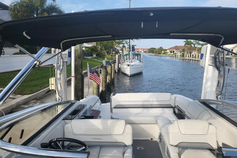 Slide: The Image of 2017 Formula 270 Bowrider boat docked in a scenic canal with palm trees. - 14