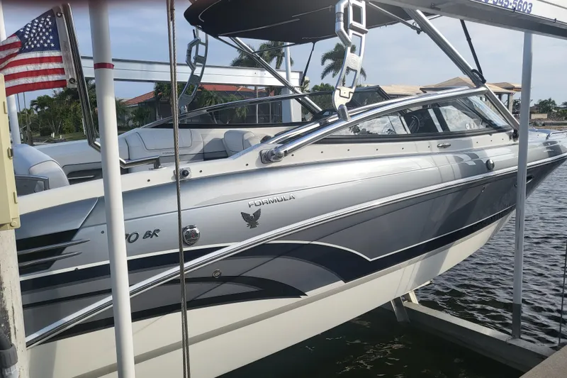 Slide: The Image of 2017 Formula 270 Bowrider boat docked, featuring sleek design and American flag. - 15