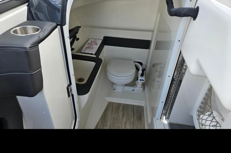 Slide: The Image of 2017 Formula 270 Bowrider interior with compact marine toilet and sink. - 29