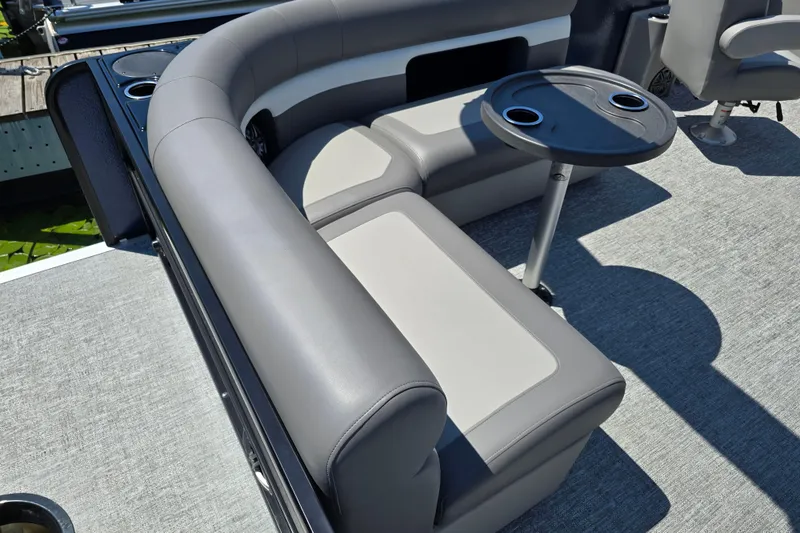 Slide: The Image of 2025 Premier 230 Sunsation RE pontoon boat interior with gray seating and table. - 14