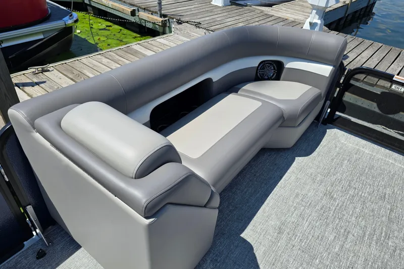 Slide: The Image of 2025 Premier 230 Sunsation RE boat with luxurious seating at a dock. - 17