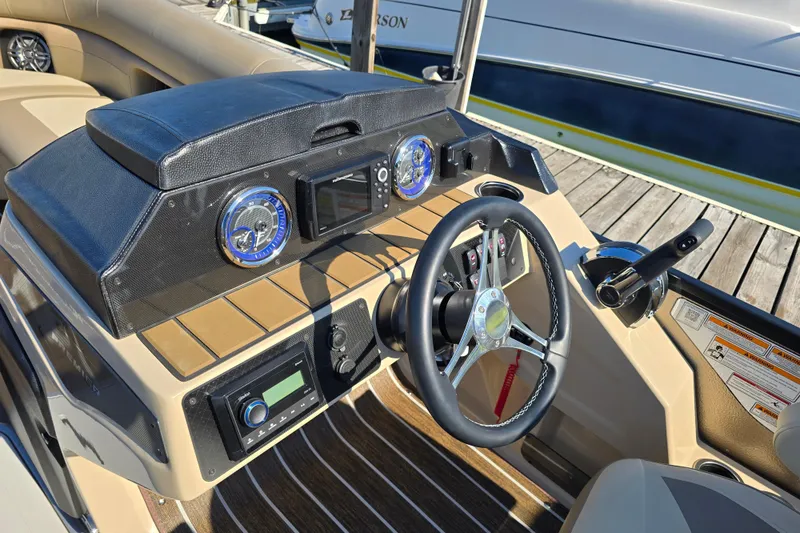 Slide: The Image of 2025 Premier 230 SunSation RF boat dashboard with steering wheel and controls. - 10