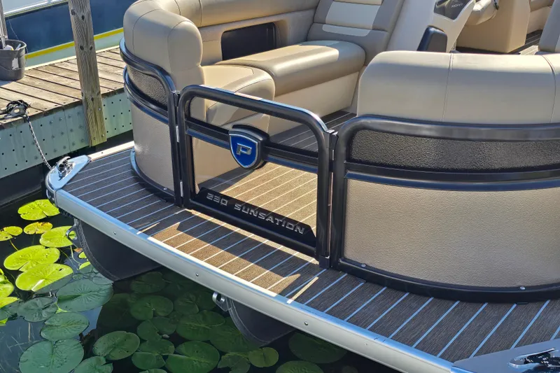 Slide: The Image of 2025 Premier 230 SunSation RF pontoon boat docked, featuring luxurious seating and sleek design. - 3