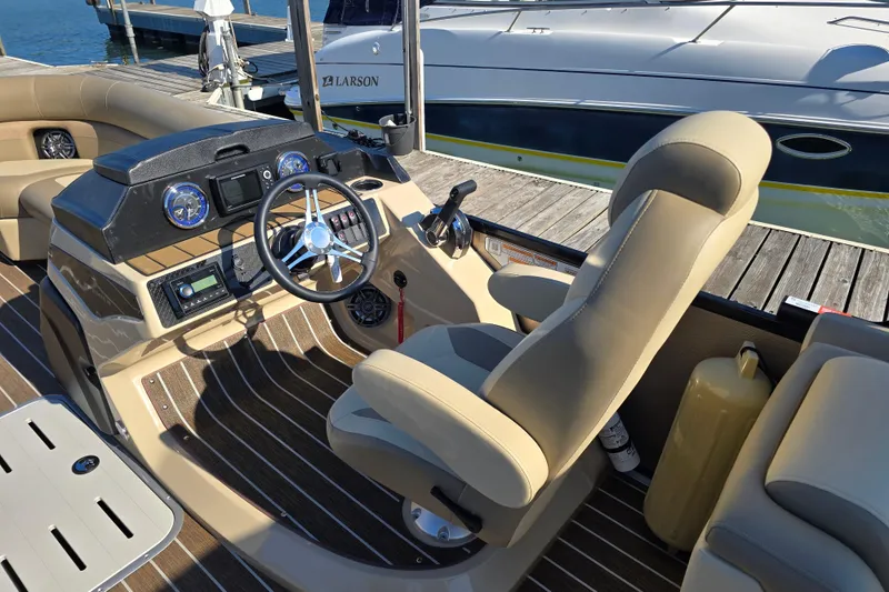 Slide: The Image of Interior view of 2025 Premier 230 SunSation RF boat with steering console and seating. - 8