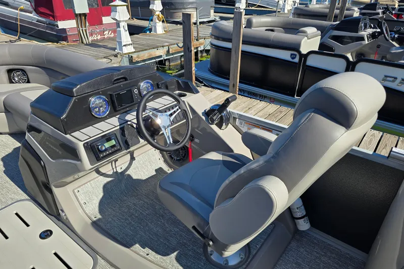Slide: The Image of 2025 Premier 230 SunSation RF boat interior with modern helm and comfortable seating. - 15
