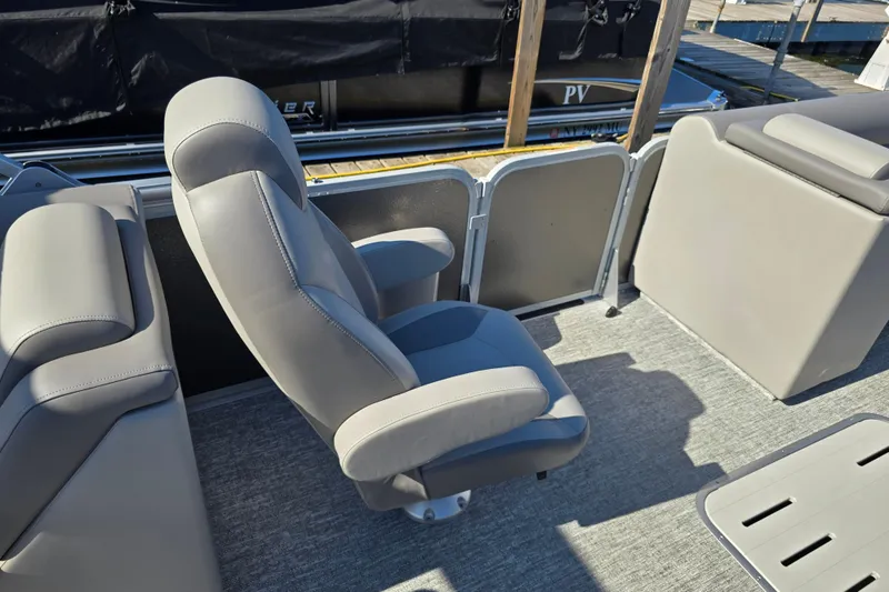 Slide: The Image of 2025 Premier 230 SunSation RF boat interior with gray seating and carpeted floor. - 18