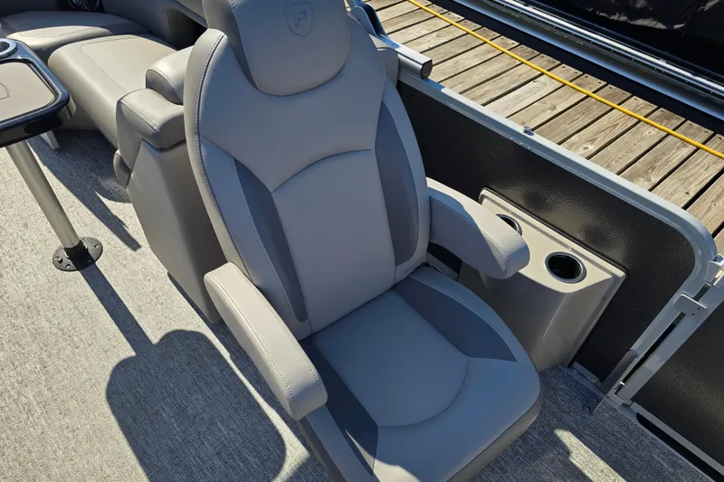 Slide: The Image of Luxurious seating on 2025 Premier 230 SunSation RF pontoon boat with cup holders and armrests. - 19