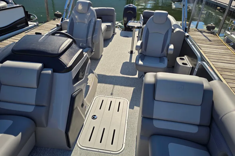 Slide: The Image of 2025 Premier 230 SunSation RF pontoon boat interior with luxurious seating and modern design. - 24