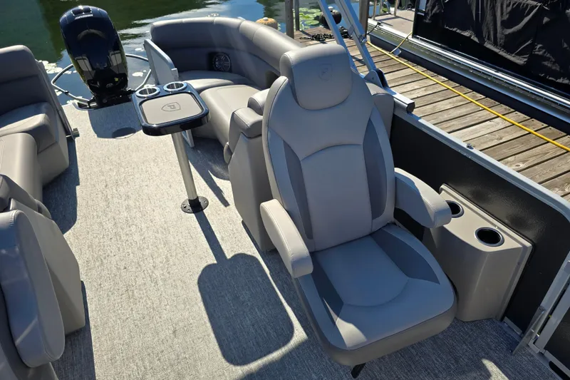 Slide: The Image of 2025 Premier 230 SunSation RF pontoon boat interior with luxurious seating and cup holders. - 26