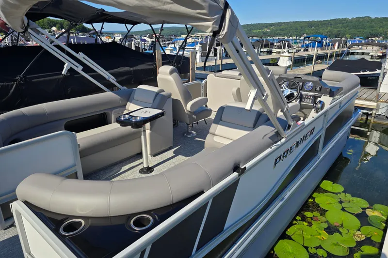 Slide: The Image of 2025 Premier 230 SunSation RF pontoon boat docked, featuring spacious seating and modern design. - 5