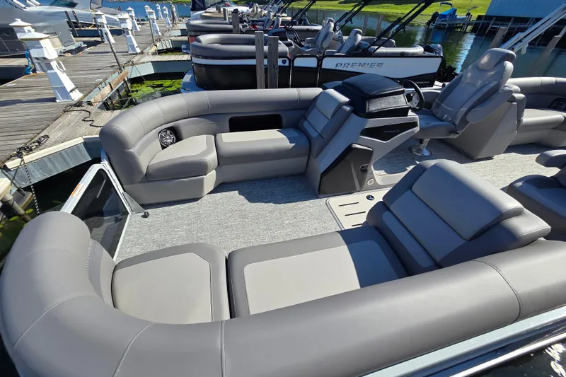 Slide: The Image of 2025 Premier 230 SunSation RF pontoon boat with luxurious seating at a dock. - 6