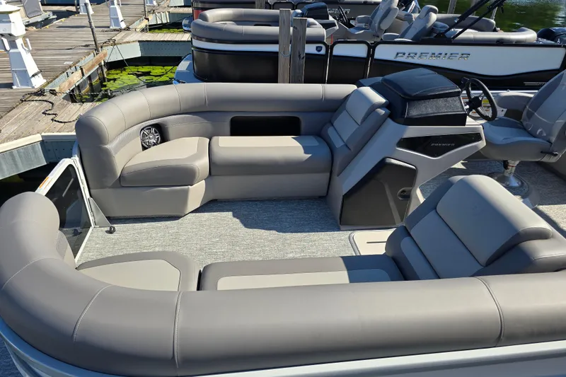 Slide: The Image of 2025 Premier 230 SunSation RF pontoon boat interior with plush seating and modern helm. - 7