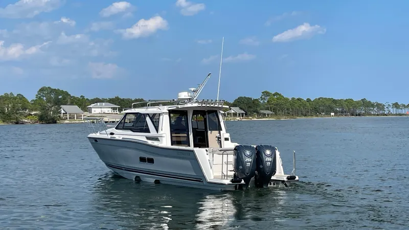 The Image of 2026 Cutwater C-288 Coupe boat on calm water, clear sky background. - 0