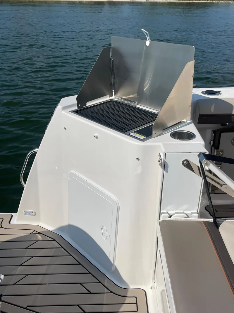 Slide: The Image of 2026 Cutwater C-288 Coupe boat with onboard grill, docked on calm water. - 17