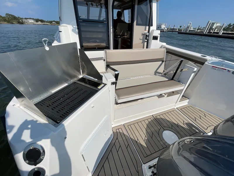 Slide: The Image of 2026 Cutwater C-288 Coupe boat with outdoor grill and seating area. - 21
