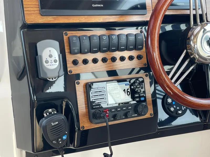 Slide: The Image of 2026 Cutwater C-288 Coupe dashboard with navigation controls and wooden steering wheel. - 32