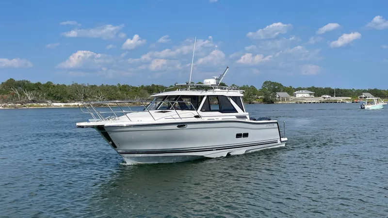 Slide: The Image of 2026 Cutwater C-288 Coupe cruising on a sunny day with clear skies. - 5