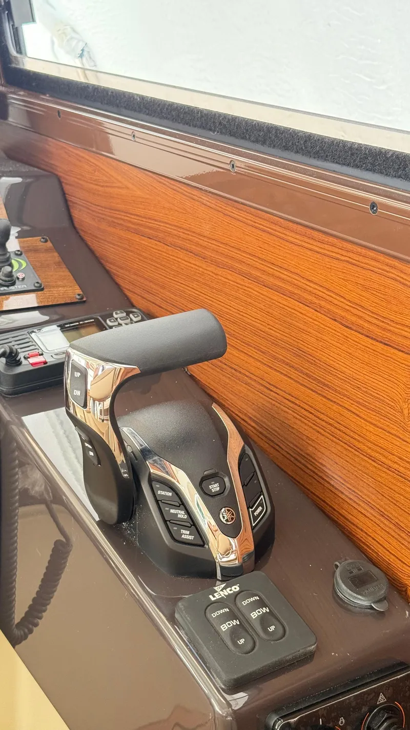 Slide: The Image of Control panel of 2026 Ranger Tugs R-27 with throttle and trim controls. - 16