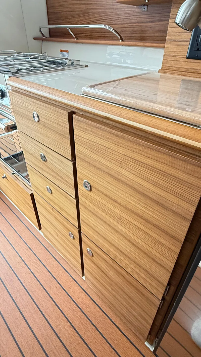 Slide: The Image of 2026 Ranger Tugs R-27 interior with wood cabinetry and flooring. - 37