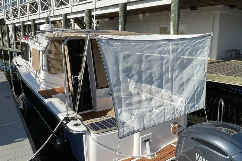 The Image of 2026 Ranger Tugs R-27 boat docked with canopy and Yamaha engine. - 0