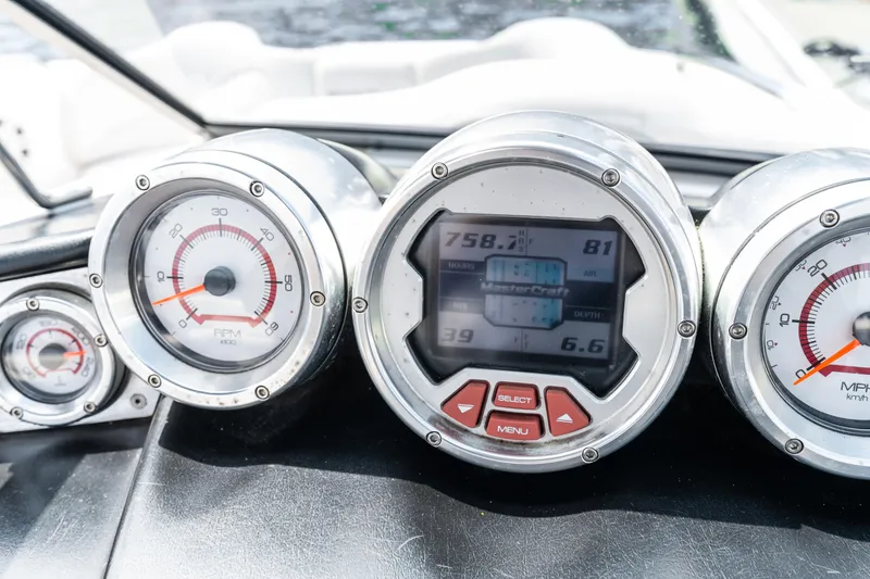 Slide: The Image of Dashboard of a 2008 MasterCraft MariStar 235 SS boat with gauges and digital display. - 3