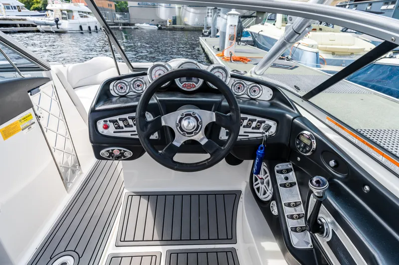 Slide: The Image of 2008 MasterCraft MariStar 235 SS boat dashboard with steering wheel and controls. - 6