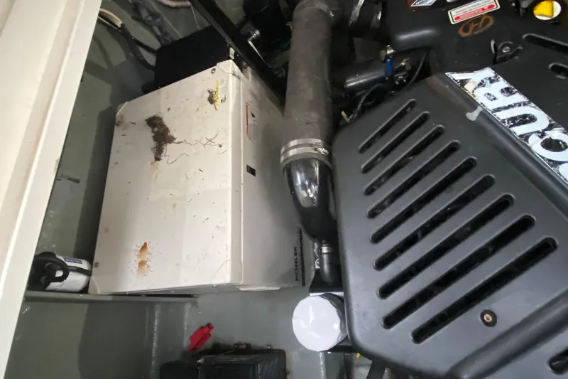 Slide: The Image of Engine compartment of a 2004 Sea Ray 340 Sundancer boat, showing machinery and components. - 30
