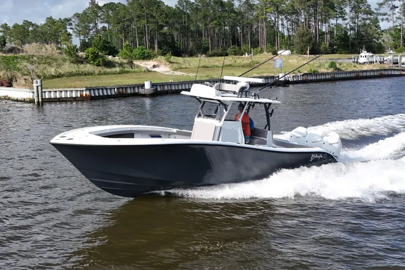 Slide: The Image of 2022 Yellowfin 34 Offshore boat cruising on a scenic waterway. - 1