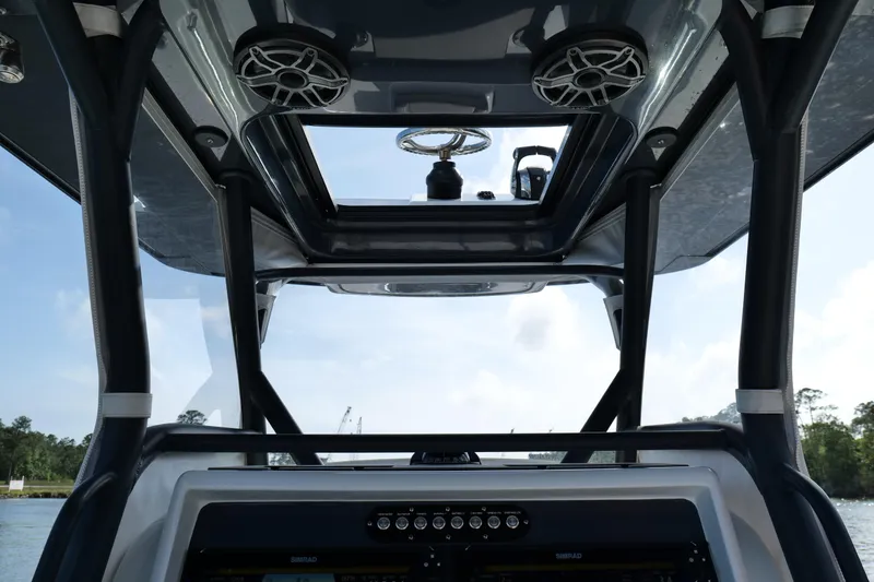 Slide: The Image of 2022 Yellowfin 34 Offshore boat interior with modern controls and speakers. - 12