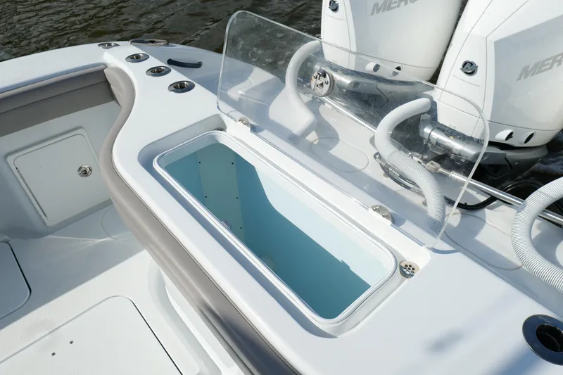 Slide: The Image of 2022 Yellowfin 34 Offshore boat with open storage compartment and dual Mercury engines. - 18