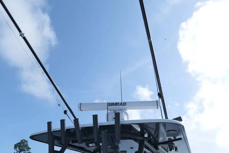 Slide: The Image of 2022 Yellowfin 34 Offshore boat with Simrad radar against a clear blue sky. - 19