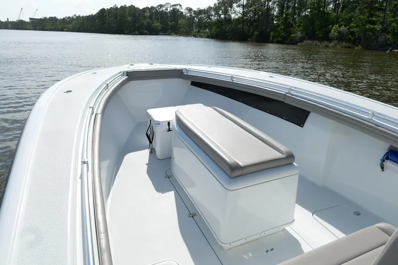 Slide: The Image of 2022 Yellowfin 34 Offshore boat interior with seating, on a calm lake. - 20