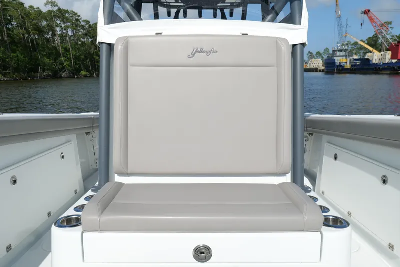 Slide: The Image of 2022 Yellowfin 34 Offshore boat seat with gray upholstery, docked by the water. - 23