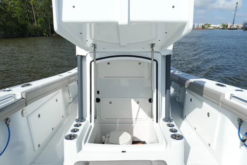 Slide: The Image of 2022 Yellowfin 34 Offshore boat interior with open storage compartment on the water. - 24