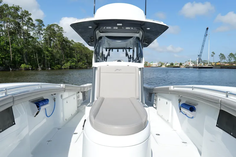 Slide: The Image of 2022 Yellowfin 34 Offshore boat on calm water, featuring spacious deck and modern design. - 26