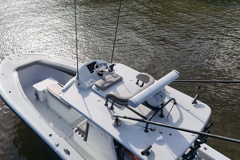 Slide: The Image of 2022 Yellowfin 34 Offshore boat on water, featuring sleek design and modern controls. - 9