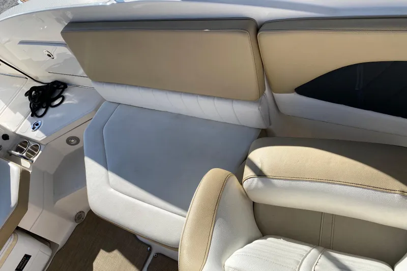 Slide: The Image of 2018 Sea Ray SPX 230 boat interior with beige and white seating. - 12