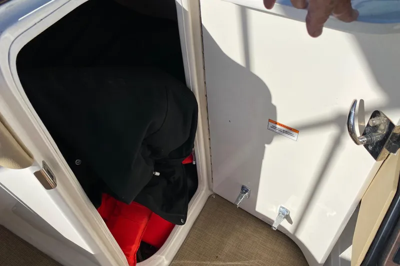 Slide: The Image of 2018 Sea Ray SPX 230 boat interior with beige and white seating. - 13