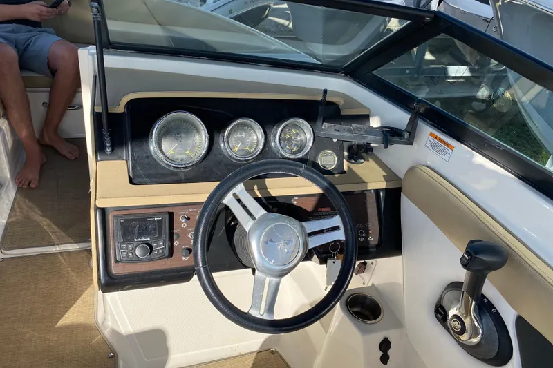 Slide: The Image of Open storage compartment on 2018 Sea Ray SPX 230 boat with life jackets inside. - 14