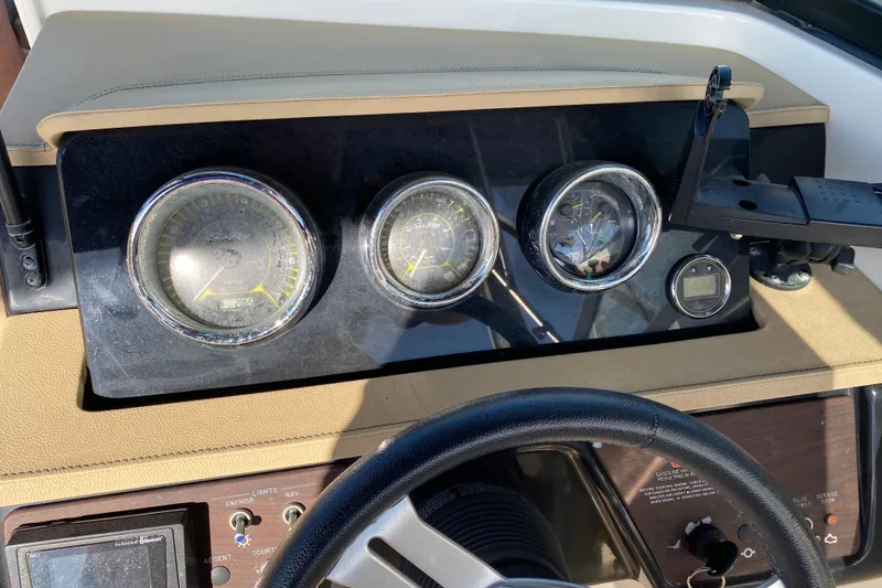 Slide: The Image of 2018 Sea Ray SPX 230 boat dashboard with steering wheel and control panel. - 15