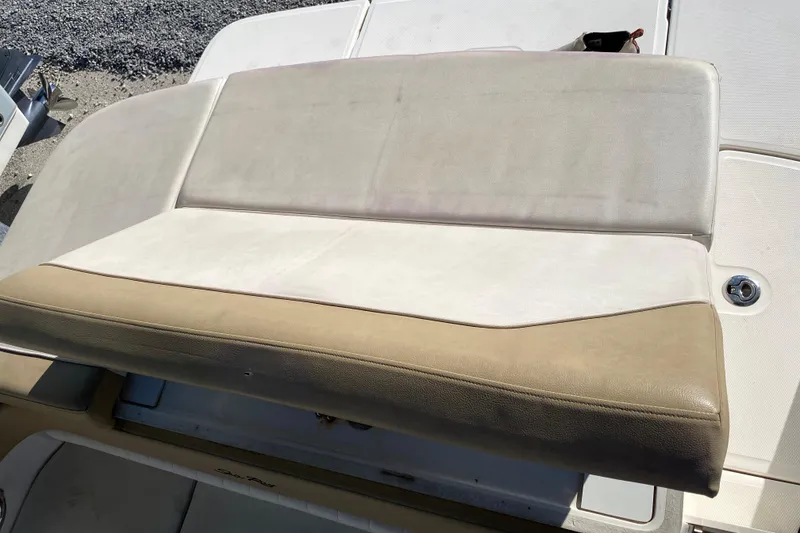 Slide: The Image of 2018 Sea Ray SPX 230 boat seating area with beige and white upholstery. - 23