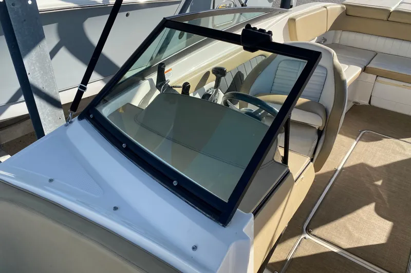 Slide: The Image of 2018 Sea Ray SPX 230 boat interior with beige seating and modern dashboard. - 8