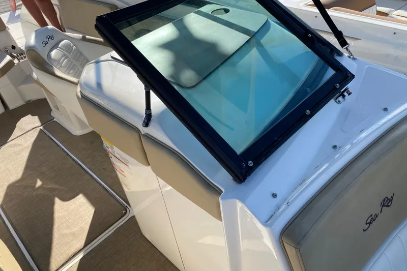 Slide: The Image of 2018 Sea Ray SPX 230 boat interior with steering wheel and seating area. - 9