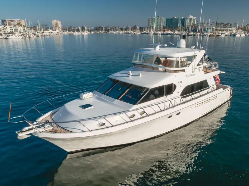 The Image of 2003 Ocean Alexander 64 Pilothouse yacht on calm water, marina in background. - 0