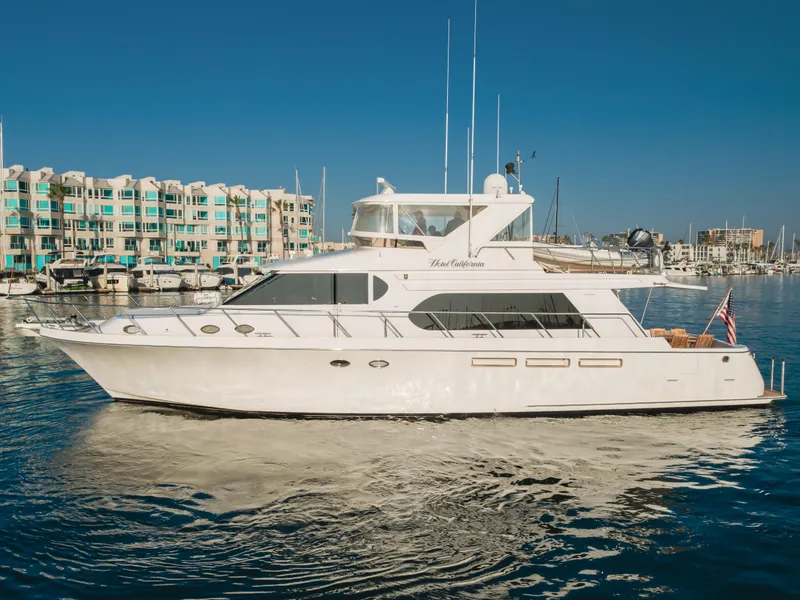 Slide: The Image of 2003 Ocean Alexander 64 Pilothouse yacht on calm water near marina. - 10