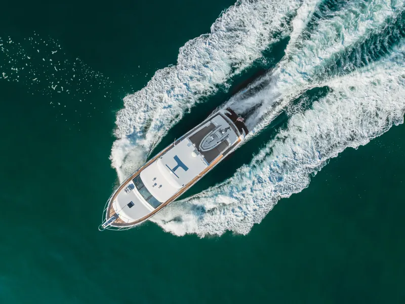 Slide: The Image of Aerial view of 2003 Ocean Alexander 64 Pilothouse yacht cruising in clear waters. - 16