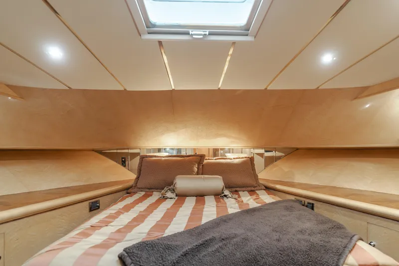 Slide: The Image of Luxurious bedroom interior of 2003 Ocean Alexander 64 Pilothouse yacht with striped bedding. - 25