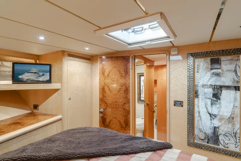 Slide: The Image of Luxurious cabin interior of 2003 Ocean Alexander 64 Pilothouse yacht, featuring elegant wood finishes. - 26