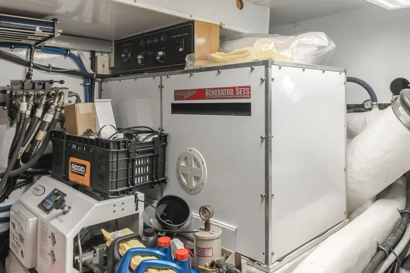Slide: The Image of Engine room of 2003 Ocean Alexander 64 Pilothouse yacht, featuring generator and equipment. - 34