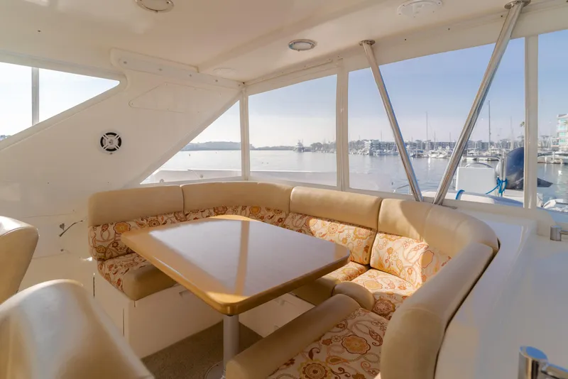 Slide: The Image of Luxurious seating area on 2003 Ocean Alexander 64 Pilothouse yacht with marina view. - 37